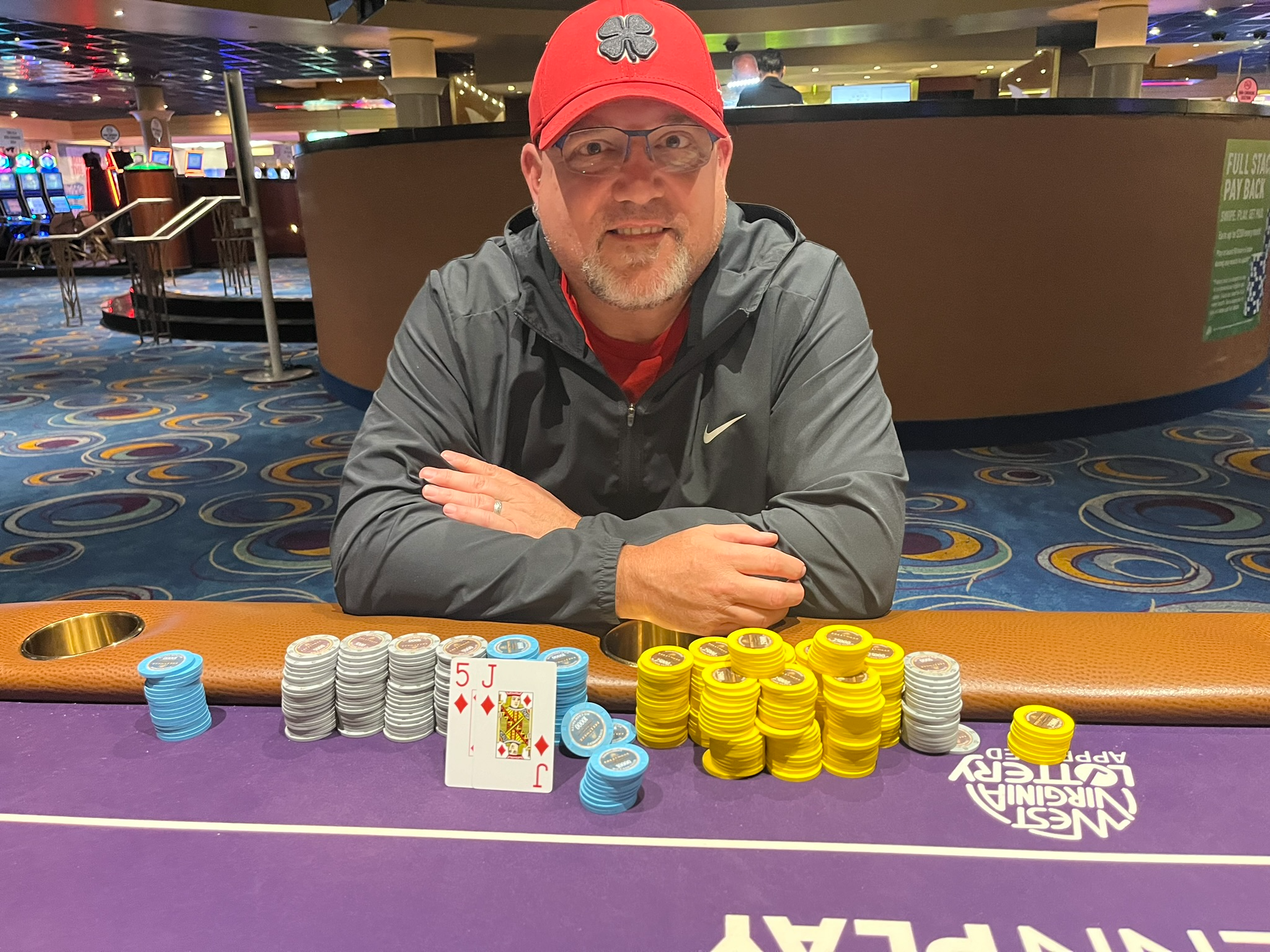Lee Childs in a red hat behind his chips after an outright win at Hollywood Charles Town