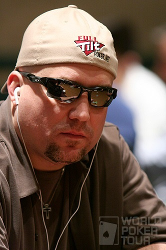 Lee Childs wearing sunglasses and a cap at a poker table